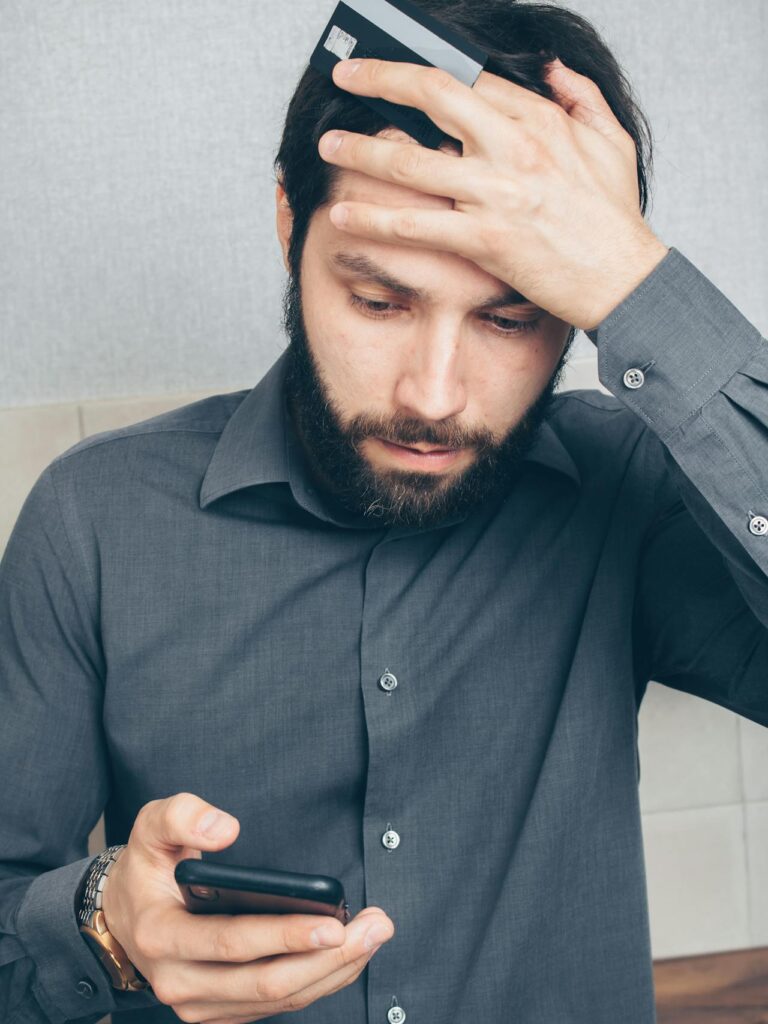 SASSA Status Check: Payday worried person checking their phone or bank app with "No Payment" alert